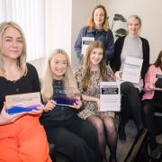 Liz Beavis, managing director of FMB (left) with the members of the team and their seven awards