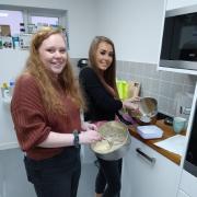 RE-BRAND: My Future project participants took part in a recent Baking on Budget activity, led by key worker Gabby (left) and project volunteer Maddie (right)