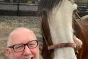 Andrew with Freda the Clydesdale horse, who would have been shot if it was not for his help
