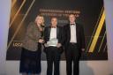 Gaynor Murphy, Head of Stakeholder Relations at sponsors United Utilities presents the Professional Services Business of the Year award to Peter Ellwood and Darren Mewse from Robinson & Co.